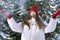 Beautiful brunette girl in red hat with bubo throws snow. Little red riding hood