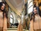 Beautiful brunette-haired model girl looks in a large mirror. fashion model posing