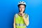 Beautiful brunette little girl wearing bike helmet and reflective vest asking to be quiet with finger on lips