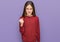 Beautiful brunette little girl wearing casual sweater angry and mad raising fist frustrated and furious while shouting with anger