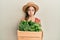 Beautiful brunette little girl wearing gardener hat holding wooden plant pot depressed and worry for distress, crying angry and