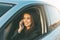 Beautiful brunette long hair young asian woman driving and speaking by mobile phone