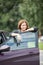 Beautiful brunette near the opened door of new car