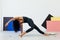 Beautiful brunette woman engaged in yoga asana gymnastics flexibility