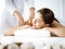Beautiful brunette woman enjoying back massage comfortable and blissful. Spa and medicine concept