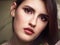 Beautiful brunette woman face closeup beauty eyes and lips makeup moody female portrait
