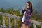 Beautiful brunette woman hiker stands at overlook