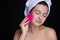 Beautiful brunette woman massage her face with a beauty massager. Her skin fresh, clean and flawless. Spa procedure concept