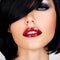 Beautiful brunette woman with shot hairstyle and red lips