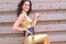 Beautiful brunette woman in tight metallic gold jumpsuit