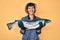 Beautiful brunettte fisher woman showing raw salmon smiling with a happy and cool smile on face