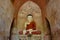 Beautiful Buddha statue inside buddhist temple with old frescos