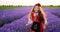 Beautiful bulgarian girl in ethnic folklore costume running on a blooming lavender field. Bulgaria 4K video