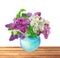 Beautiful Bunch of Lilac in the Vase on wooden table over white