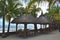 Beautiful bungalows on the edge of a heavenly beach. Vacations, tropical, beach backgrounds.