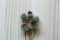 Beautiful burdock flowers on light wooden table, top view