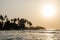 Beautiful Bureh Beach during sunset with silhouettes of palms and surfers, Sierra Leone, Africa