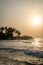 Beautiful Bureh Beach during sunset with silhouettes of palms and surfers, Sierra Leone, Africa