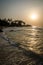 Beautiful Bureh Beach during sunset with silhouettes of palms and surfers, Sierra Leone, Africa