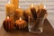 Beautiful burning beeswax candles on wooden table