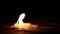 Beautiful burning candle with flame from wick and wax shining light into the darkness on wooden table background with copy space f