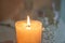 Beautiful burning candle with flowers on shelf, closeup