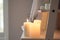 Beautiful burning candles on shelf indoors