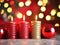 Beautiful burning red New Year candles and Christmas balls on the background of shiny round bokeh