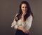 Beautiful business toothy smiling woman with long brown healthy hair style standing with folded arms in white stripped shirt.