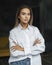 Beautiful business woman. Blonde in white shirt. Purposeful woman posing with crossed arms. Isolated female portrait.