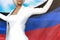 Beautiful business woman holds Donetsk Peoples Republic flag in hands behind her back on the blue sky background - flag concept 3d