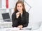 Beautiful business woman sitting at office workplace half turn looking in notebook.