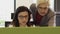 Beautiful business women wearing glasses working in call center with senior woman managing her