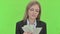 Beautiful Businesswoman Counting Money against Chroma Key