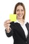 Beautiful businesswoman showing a blank yellow paper note