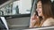 Beautiful businesswoman talks on phone in the car