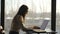 Beautiful businesswoman working at laptop in office