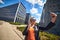 Beautiful businesswomanspeaks via video link on the background of modern architecture buildings in the business center Wroclaw,