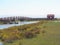 A beautiful cabin surrounded by a boardwalk and wildflowers in marsh