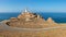 The beautiful Cabo de Gata lighthouse in the sunlight on the Mediterranean Sea.