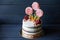 Beautiful cake with candies, fruit and meringue