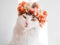 Beautiful Calico Cat with a wreath on his head. Cute kitty in a flowers diadem on her head sits in the sun and looks