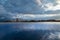 Beautiful calm blue lake, afternoon clouds on the sky