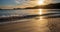 Beautiful and calm golden sand beach with small waves lapping at the shore and driftwood coral at sunset