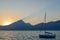 Beautiful calm and peaceful Lake Garda at sunset with boat, Italy