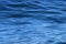 Beautiful calm ripples on deep blue ocean