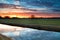 Beautiful calm sunset over river in farmland