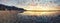 Beautiful Camps bay beach in cape town, south Africa under reflecting sunset sky on the water