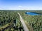 Beautiful Canada camper bus driving on road endless pine tree forest with lakes moor land aerial view travel background