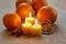 Beautiful candles and juicy oranges on jute table cloth
